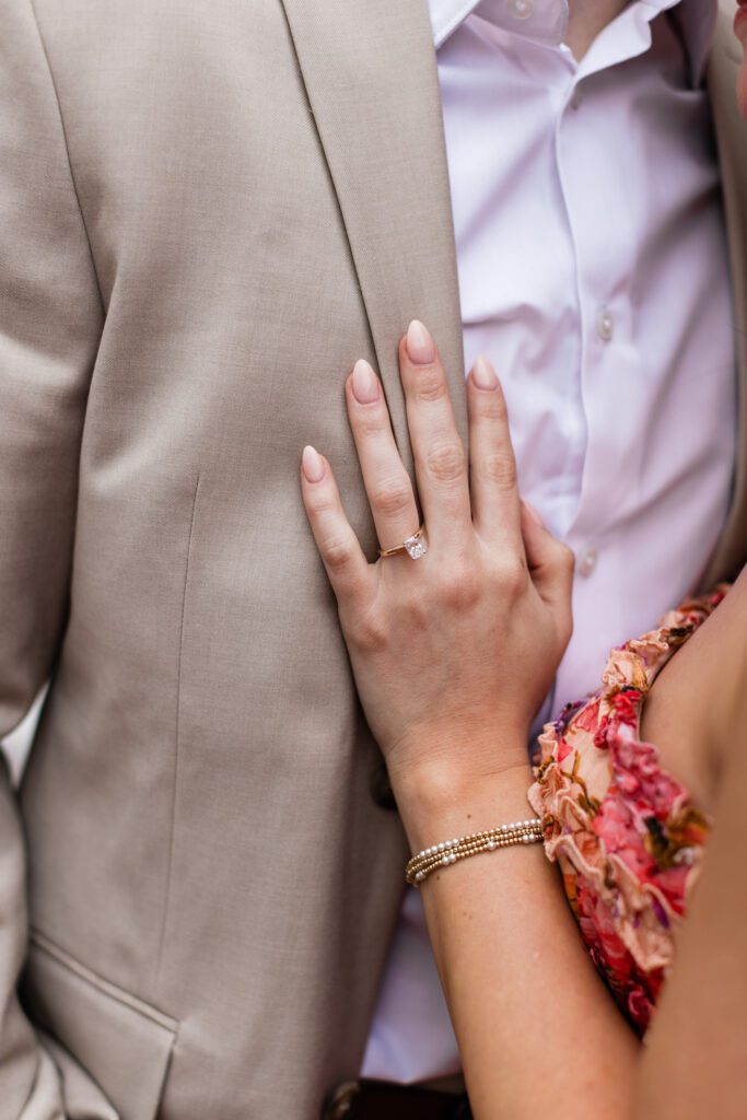 Ring on hand with couple in the background at Partridge Inn