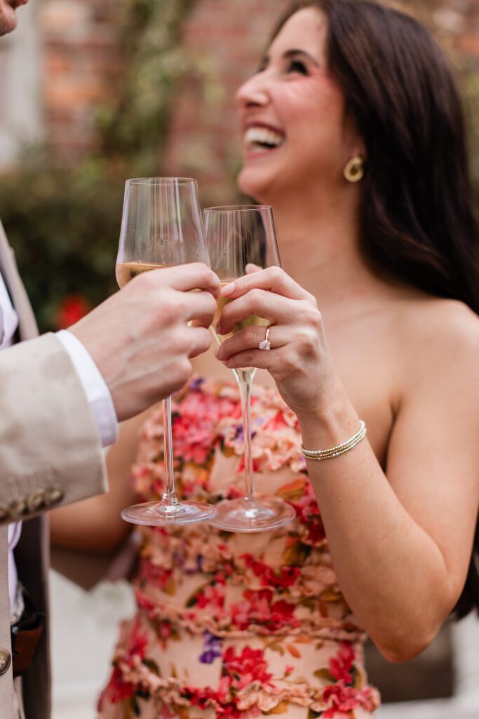 Ring on hand with couple in the background at Partridge Inn