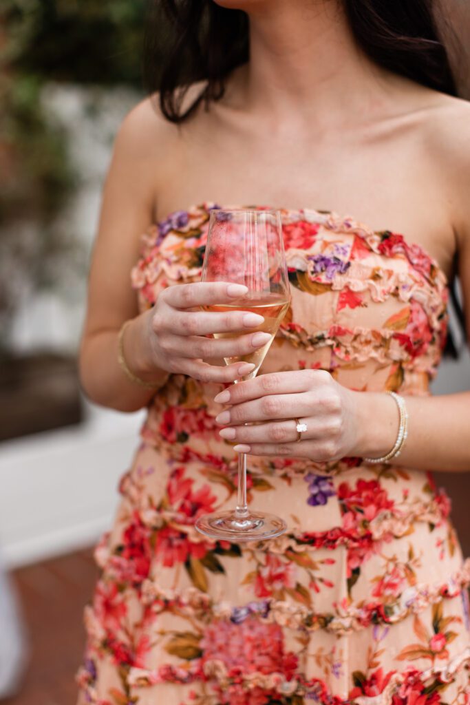 Ring on hand with couple in the background at Partridge Inn