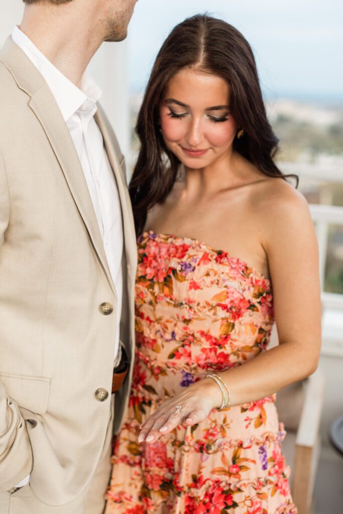 Ring on hand with couple in the background at Partridge Inn
